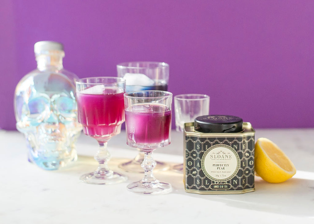 purple tea in goblet with skull bottle