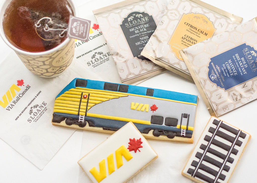 train cookies with cup of tea and sachet envelopes